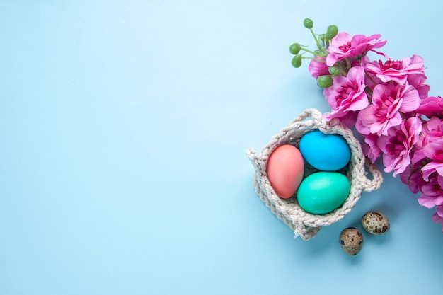 top view colored painted eggs inside ropes on blue surface holiday colourful concept ethnic ornate