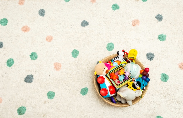 Photo top view on colorful baby toys on a carpet  toys in the floor with copyspace