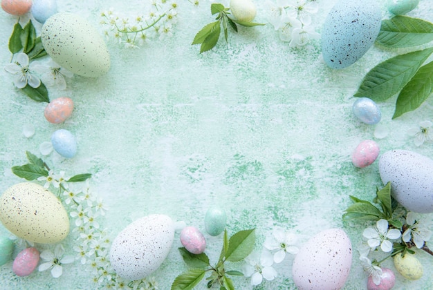 Top view of colorful easter eggs on green wooden background