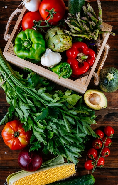 Top view of colorful fresh farm vegetables on a wooden table, balanced diet