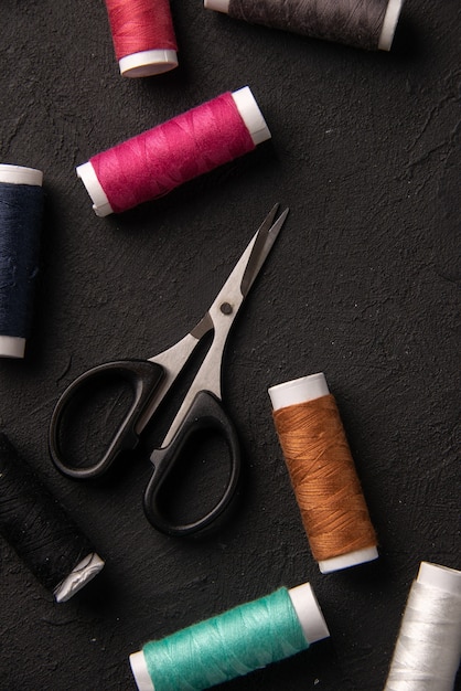 Top view of colorful threads on dark wall