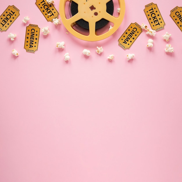 Photo top view composition of cinema elements on pink background with copy space