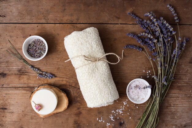 Top view composition with lilac flower on wooden background