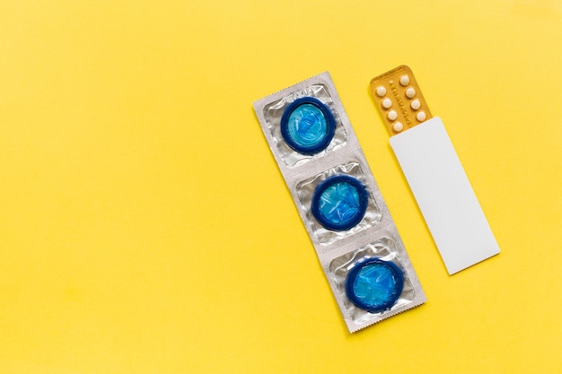 Top view of condoms and birth control pills