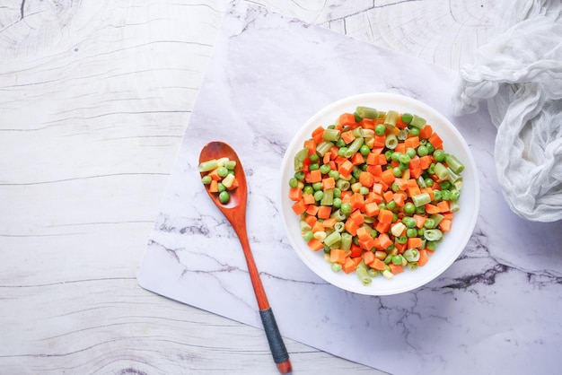 Top view of corn carrot and beans in a bowl