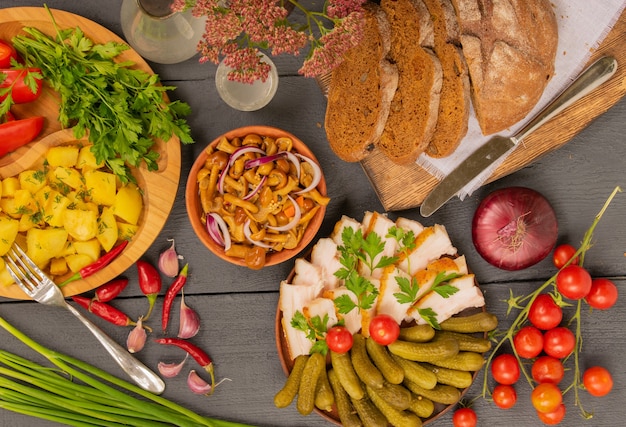 Top view of a country style wooden table full of fresh handmade products and delicious rustic snacks