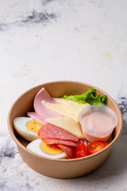 top view of a craft breakfast plate sausage tomato egg and cheese