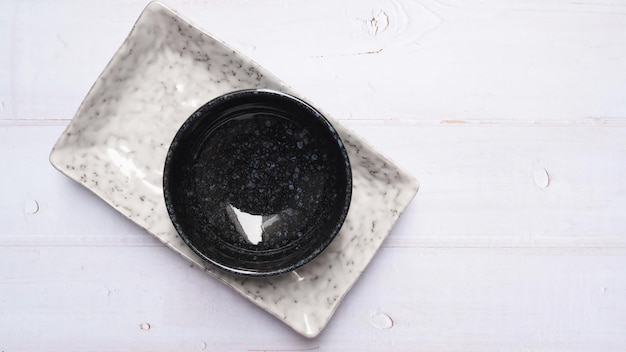 Top view of crockery set with porcelain ceramic square plate round dish and cup bowl