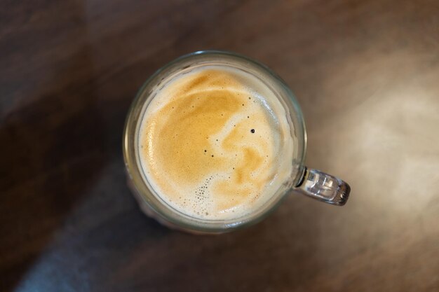 Top view a cup of coffee on wooden table with work break time food concept