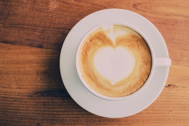 top view cup and coffee on wooden table