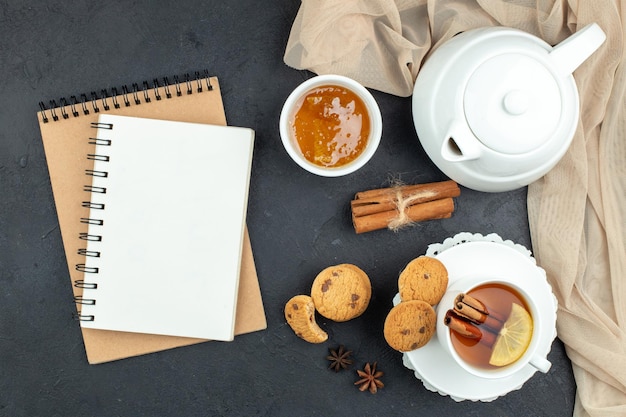 Top view cup of tea with honey and biscuits on dark background meal ceremony breakfast color lemon cookie lunch