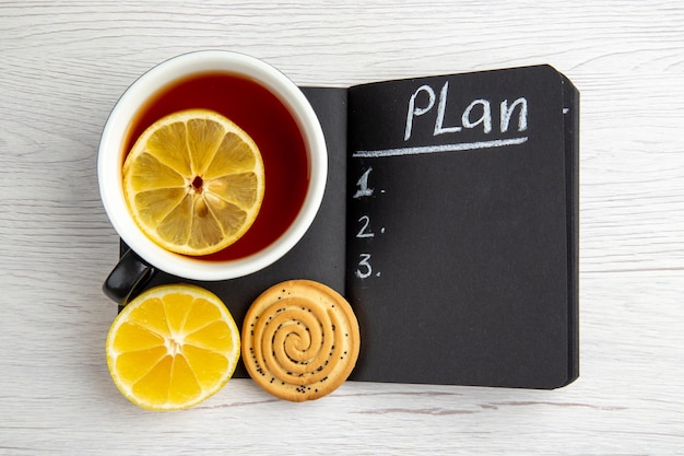 Top view dark open notepad with cup of tea on white background sweet business woman regime female break job worker office plan