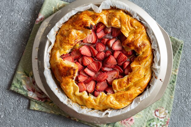 Top view of delicious baked tart with strawberries