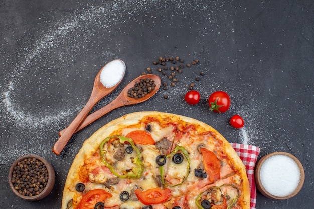 Top view delicious cheese pizza with red tomatoes on dark surface