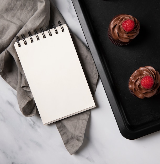 Top view of delicious chocolate cupcakes with raspberry