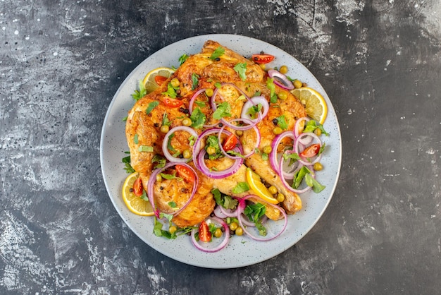 Top view of delicious dinner fried chicken dish with various spices and foods on dark color background