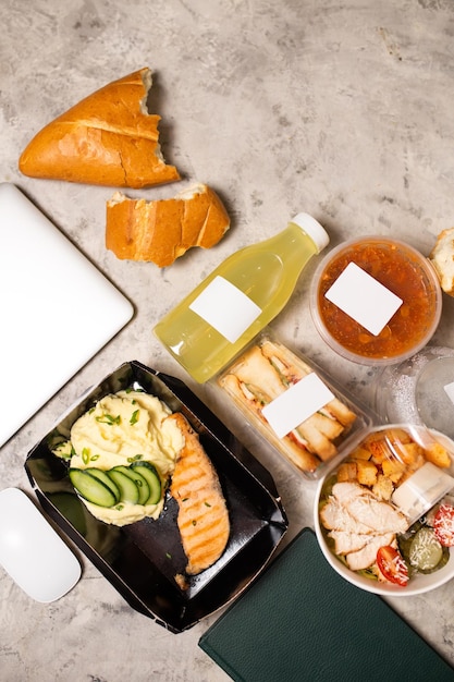 Top view of delicious lunch with laptop on table