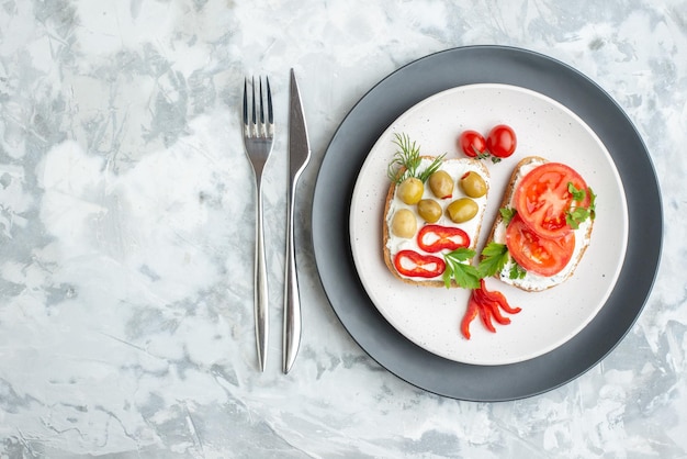 Top view delicious sandwiches with tomatoes and olives inside plate white background bread food lunch meal toast sandwich horizontal