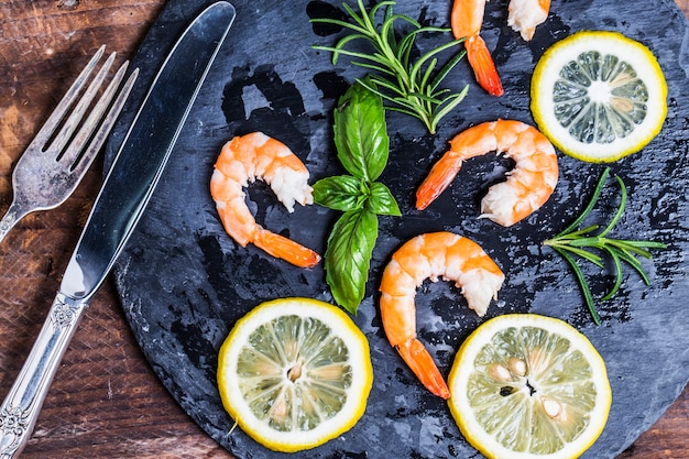 Top view of delicious shrimps with lemon slices