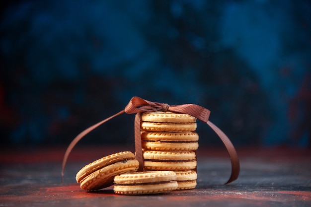 Top view of delicious stacked cookies on mix colors background with free space