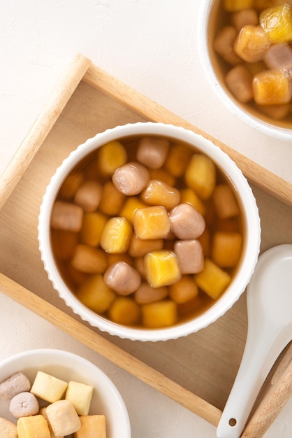 Top view of delicious sweet taro tapioca ball syrup soup in a white bowl for serving