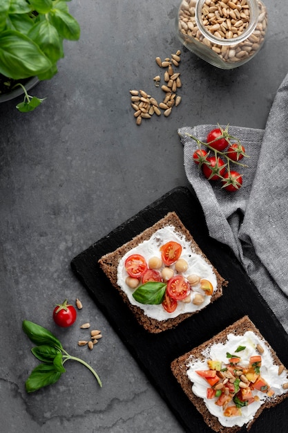 Top view delicious toast slices with cherry tomatoes