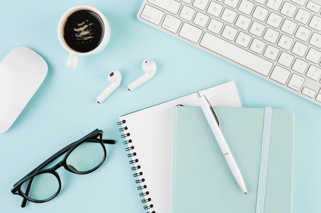 Top view of desk with notebook and glasses