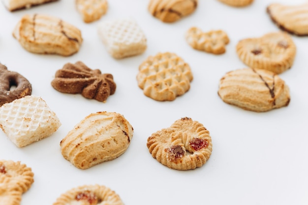 Top view different cookies on table top Flat lay of various cookies on white background