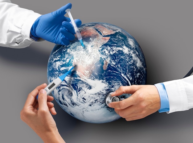 Top view doctors vaccinating the earth