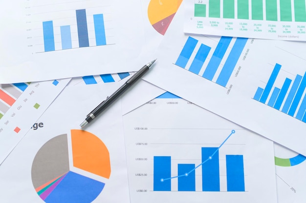 Top view of Documents with analytics data lying on tableselective focusx9