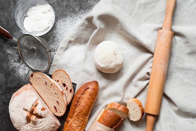 Top view dough with bread mix and rolling pin