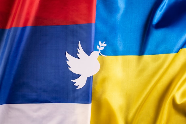 Top view dove shape on ukrainian and russian flags