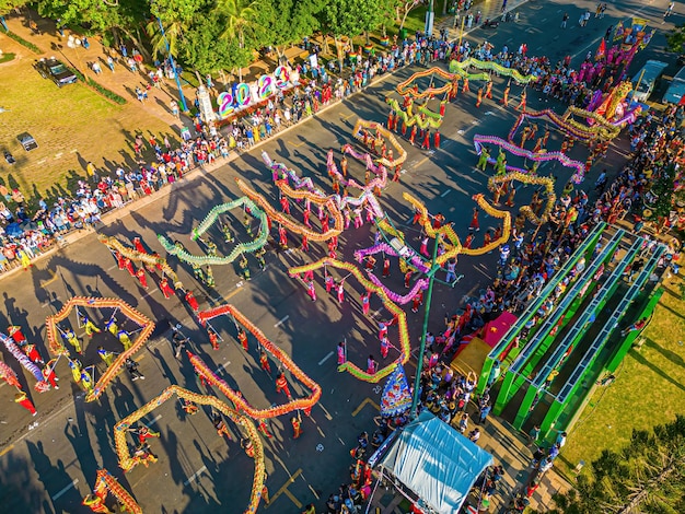 Top view of dragon dance perform celebration new year Group of people perform a traditional lion dance and dragon dance Guinness record performance of 54 Dragons dance on the street Vung Tau