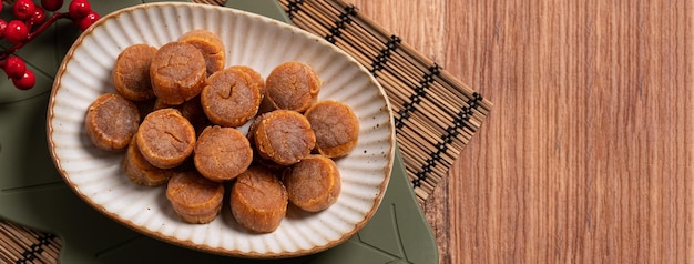 Top view of Dried scallop on wooden table for Chinese lunar new year boxed gift.