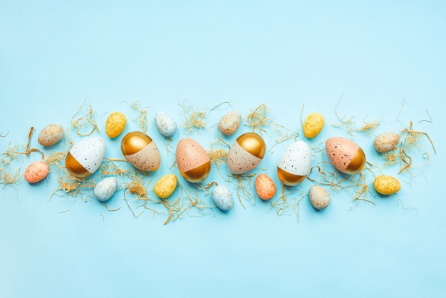 Top view of easter eggs colored with golden paint and different colors