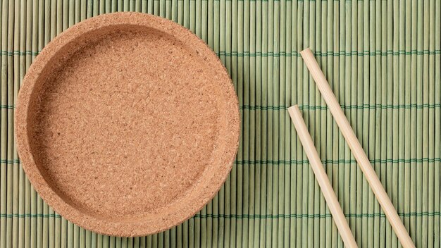 Top View of EcoFriendly Bamboo Chopsticks on Stylishly Crafted Cork Plate