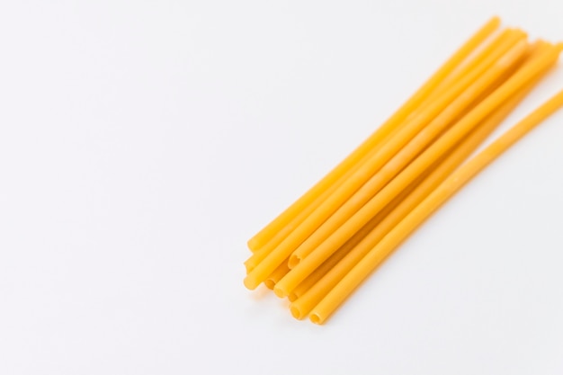 Top view of ecofriendly pasta straws on light background with copy space