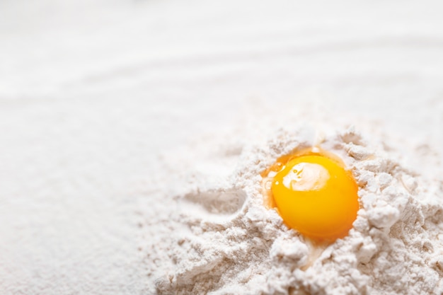 Top view eggs, dough, flour  on black table background