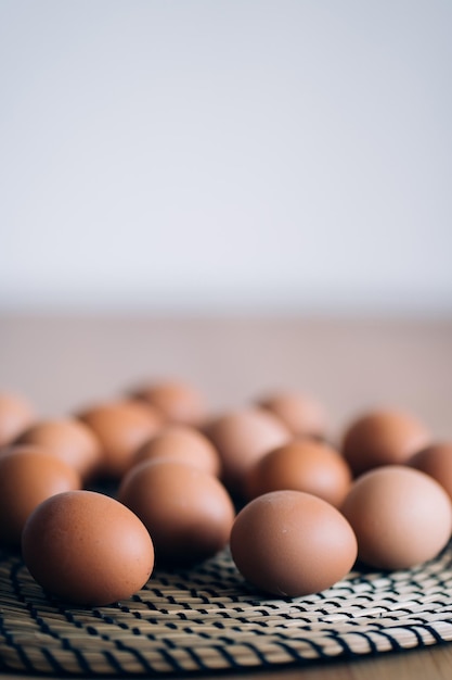 Top view eggs on the table round wicker Board in the kitchen