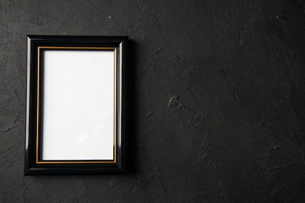 Top view of empty picture frame on a dark wall