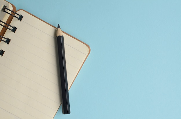 top view empty space from a notebook and blue background