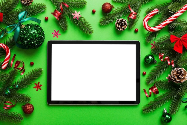 Top view of empty tablet on Christmas background made of new year decorand festive decorations New year holiday concept Mockup