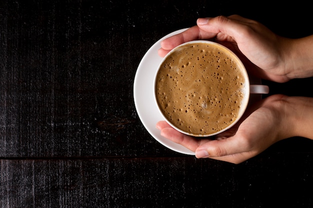 Top view on espresso on a wooden background