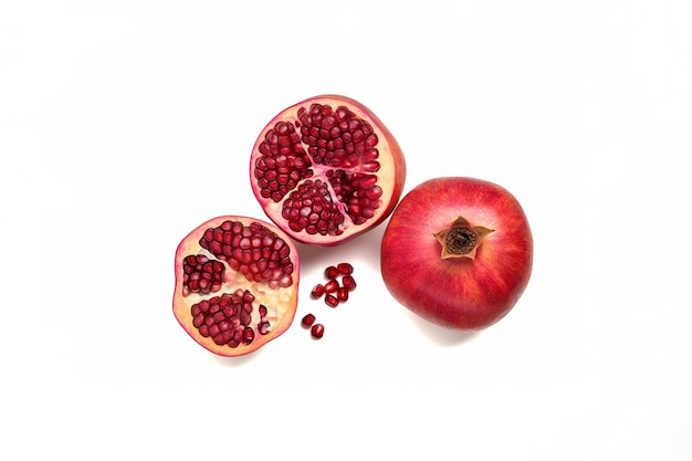 Top view exotic and delicious whole and part of pomegranate on white background