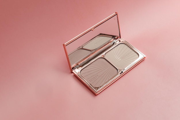 Top view eye shadow blush powder sculptor in a case pink isolated background place for text aesthetics of makeup artist makeup makeup for yourself beauty salon