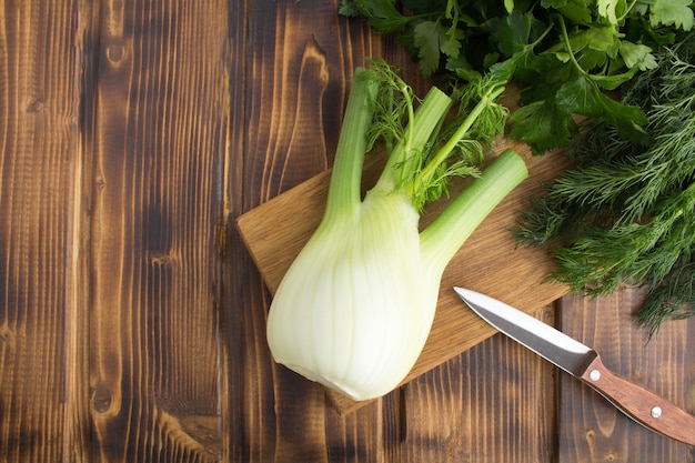 Top view of fennel, dill and parsley on the cutting board