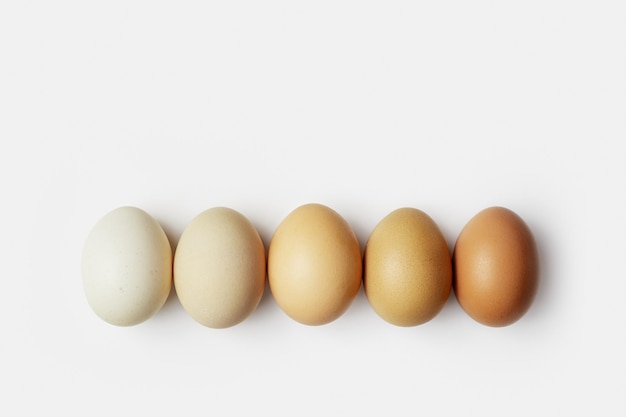 Top view of five boiled chicken eggs in row Minimal style photo made of natural colors eggs on