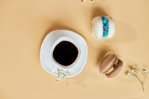 Top view flat lay cake macaron french cookies macaroons and cup of coffee