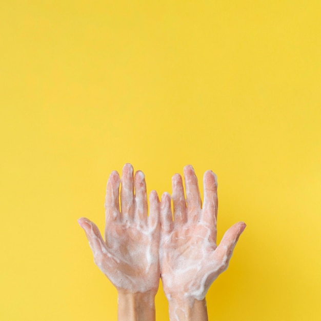 Top view of foamy hands with copy space