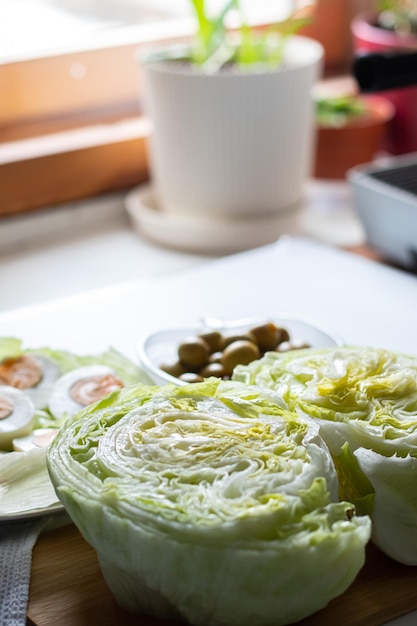 top view of food ingredients eggs green olives and lettuce for salad preparation